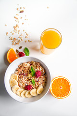 Breakfast with oatmeal and orange juice on white background