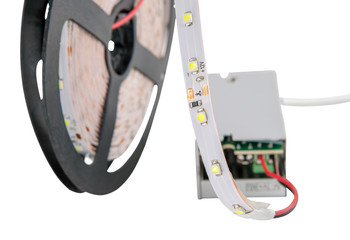 LED ribbon on the reel is connected to a voltage converter.