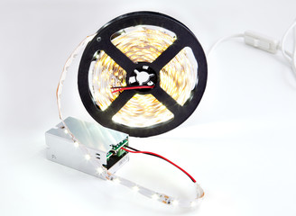 Close-up Bobbin glowing LED strip connected to the converter vol