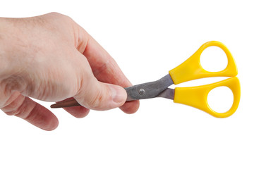 Domestic steel scissors with yellow plastic handle isolated on w