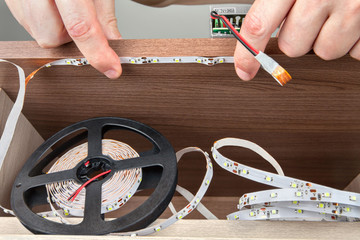 Installation of decorative LED lighting inside the furniture.