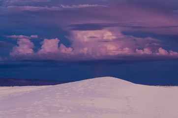 Naklejka na ściany i meble A beautiful purple sunset with cloudy stormy sky at White Sand Dunes National Monument.