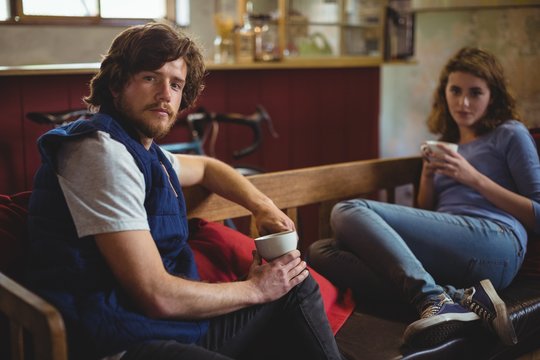 Portrait of mechanics sitting on bench
