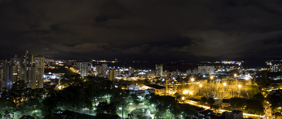 Naklejka premium Panoramic night photo of the city Sao Jose dos Campos - Sao Paulo, Brazil - with cloudy sky