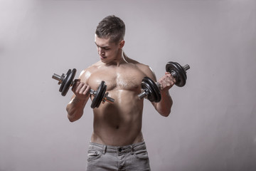 Fototapeta na wymiar Young man bodybuilder exercise dumbbells arms.