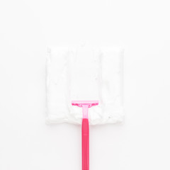 conceptual photo of women razor and shaving foam on the white background. not isolated.