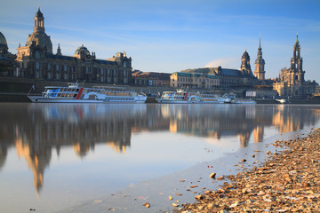 Fototapeta na wymiar Skyline of Dresden with Elbe river, passenger ships and In background the Frauenkirche at sunrise
