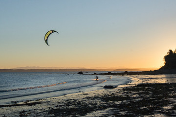 Kitesurfing in the early morning light. North Beach, Port Townsend, Washington