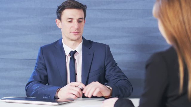 Young Businessman gives a paper to his workmate