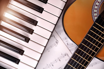 Fototapeta premium Piano and guitar with shine and sheet music background top
