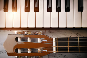 Piano and tuning peg guitar and sheet music background top
