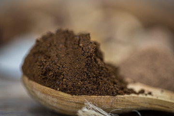beautiful little wooden spoon with coffee on  background