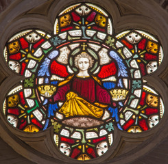ROME, ITALY - MARCH 9. 2016: The angel with the symbolic crowns on the stained glass rosette of All...