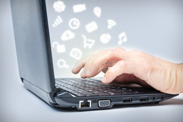 Obraz na płótnie Canvas Multitasking on Laptop With Media Icons
