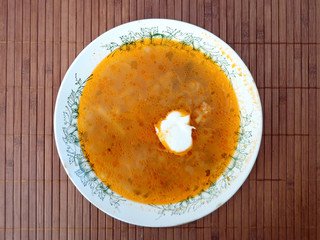 Meat soup in the bowl on the table