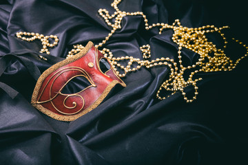 Carnival mask isolated on black satin background