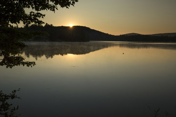 Fototapeta na wymiar Sunrise on Mountain View Lake, Sunapee, New Hampshire.