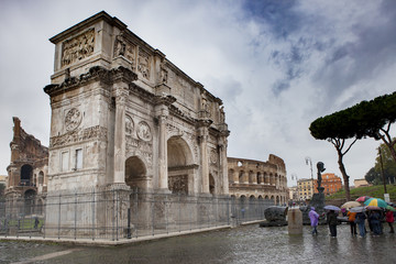 tourist looking to colosseum in rome italy in raining day