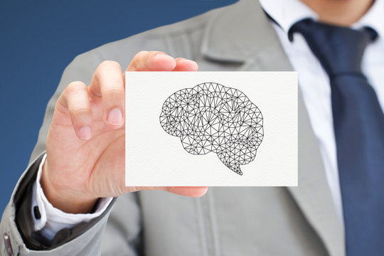 Businessman hand holding card with brain.
