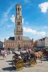 Foto op Canvas BRUGGE, BELGIUM - JUNE 13, 2014: The Carriage on the Grote Markt and Belfort van Brugge in background. © Renáta Sedmáková