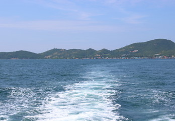 Water trail surface behind a ferry boat.