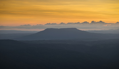 Naklejka na ściany i meble panoramic view of mountain during sunset with beautiful orange s