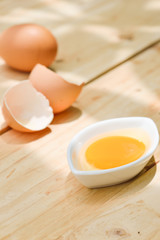 Raw egg on wooden table