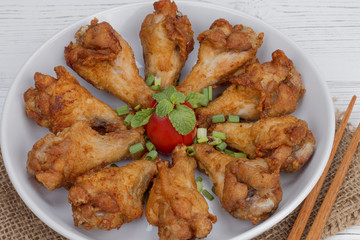 Fried chicken with fish sauce on white wood table, Thai food