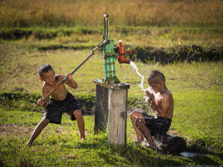 Two young boy rocking groundwater bathe in the hot days, Country