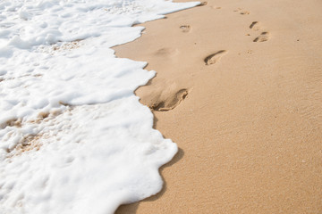 Footprints in the sand at sunset