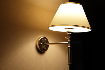 Glowing lamp on the wall in hallway