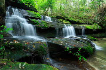 The landscape photo, beautiful rainforest waterfall in deep forest at Phu Kradueng National Park in Thailand