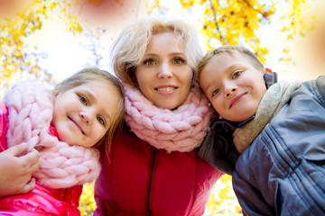 Fototapeta premium mother and two children looking down in autumn