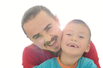 Father and son happy smiling in sun rays