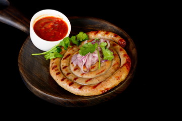 twisted sausage on black background