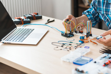 Workplace of engineer experimenting with electronics, free space. Programmer checking his new invention. Modern technologies, electronics, diy product engineering