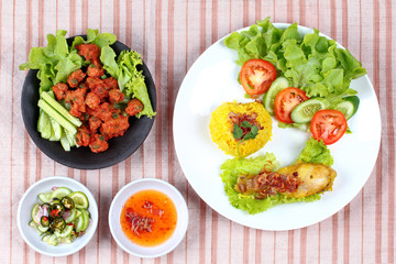 Muslim yellow rice with chicken and curried fish cake.