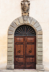 Fototapeta na wymiar Old wooden door in a stone house Italian