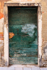Old wooden door in a stone house Italian