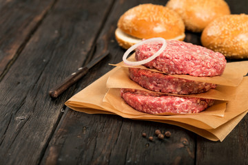 Raw ground beef meat burger steak cutlets on wooden table
