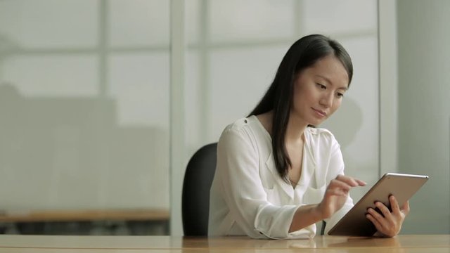 MS Business Woman Using A Digital Tablet At Desk / Singapore