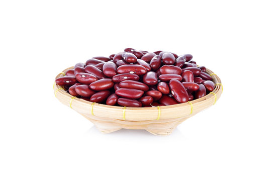 uncooked red beans in bamboo basket on white background
