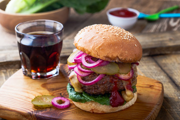 Burger with  gherkins, red onion and lettuce