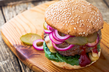 Burger with  gherkins, red onion and lettuce