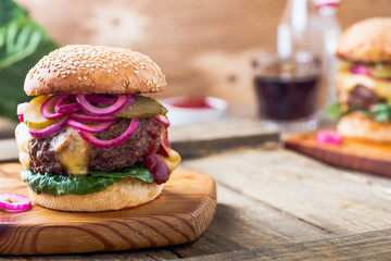 Burger with  gherkins, red onion and lettuce