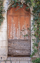 Old wooden door in the entrance stone French house