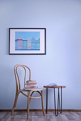 Fototapeta premium Simple interior with stool and decorations on blue wall background