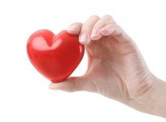 Female hand holding little ceramic heart on white background