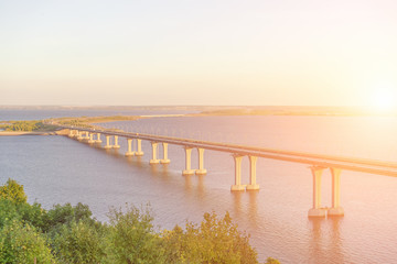 Obraz premium Highway bridge over the river in the sunlight