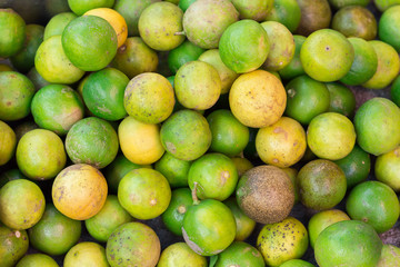 Fresh green lemons and limes for making